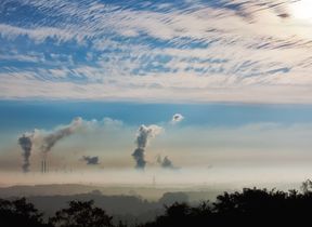 billows-of-smoke-pollution-rising-into-a-cloudy-sky