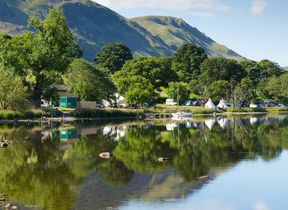 boats-and-campsite-by-a-lake