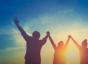 happy-teamwork-hold-hands-up-as-a-business-successfu