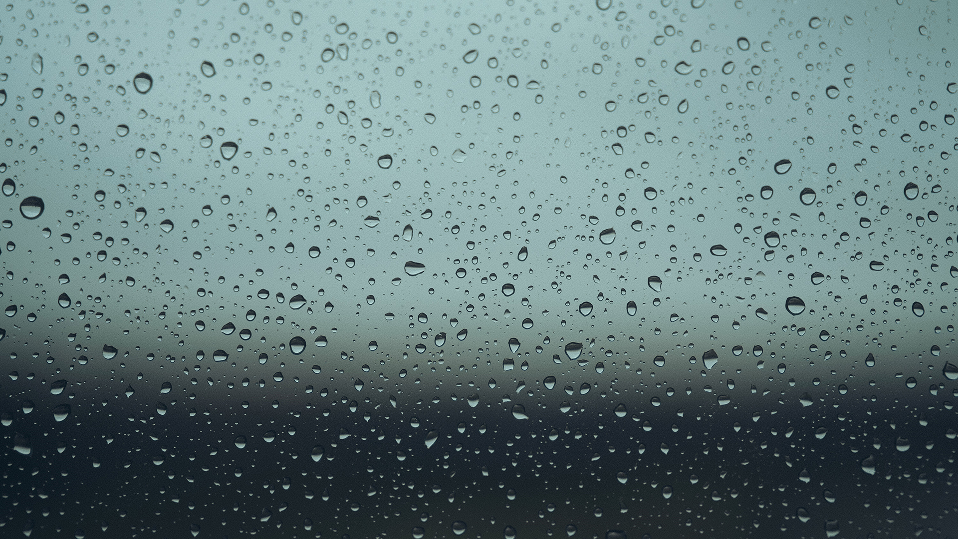 raindrops-neatly-positioned-on-window-grey-background-london