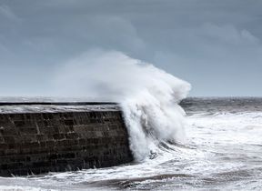 waves-crashing-against-a-harbour-wall