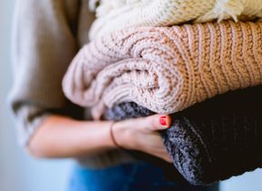 woman-carrying-folded-blankets-photo-dan-gold