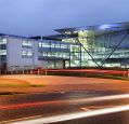 An external view of the Met Office building at night.