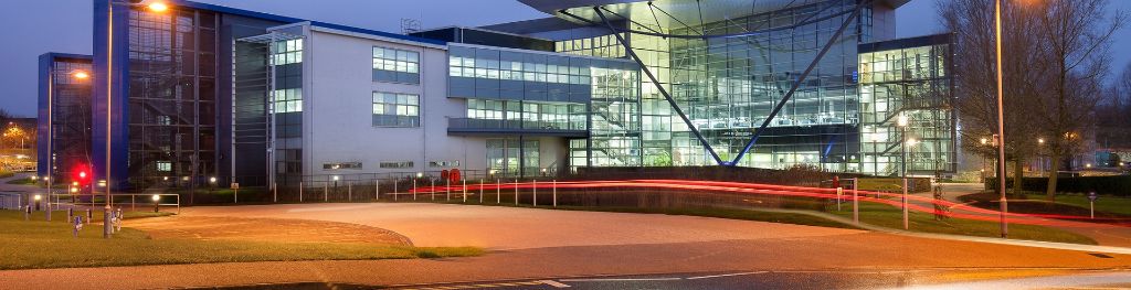 An external view of the Met Office building at night.