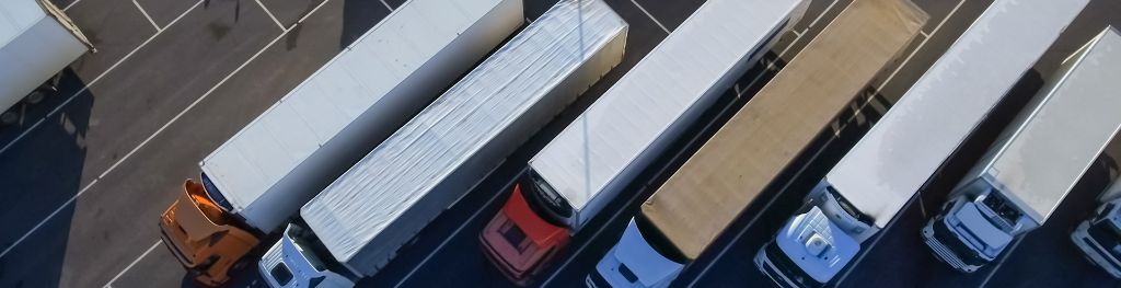 Six deliveries lorries in parking bays, viewed from above