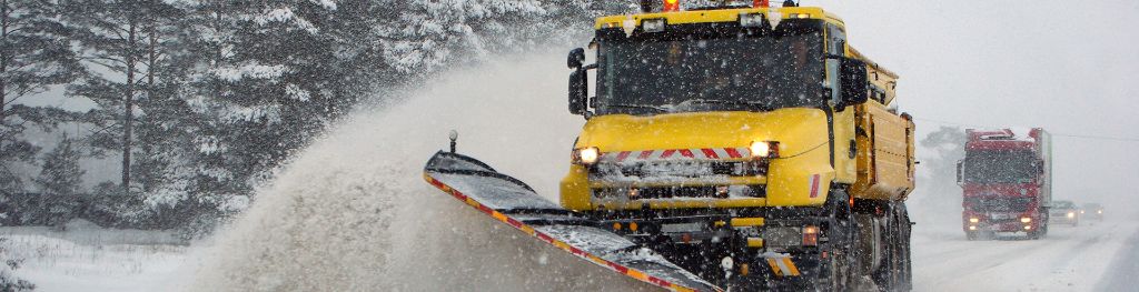 Gritter lorry in snow ploughing snow ahead of itself