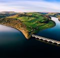 An island in the middle of a water reservoir relied to the mainland by a bridge