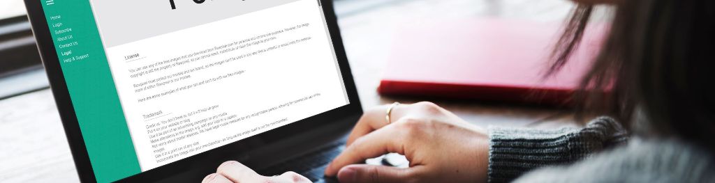 A person using a laptop at a desk. The word 'policy' is displayed in bold on the screen.