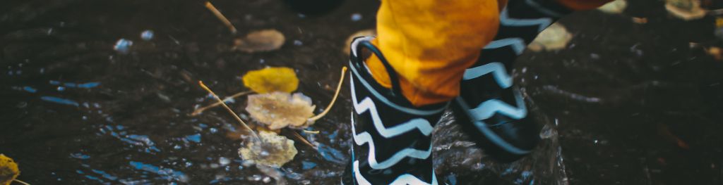 Wellies splashing in the rain. Photo Daiga Ellaby