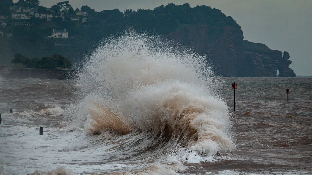 A wave hitting coastal defences in a storm
