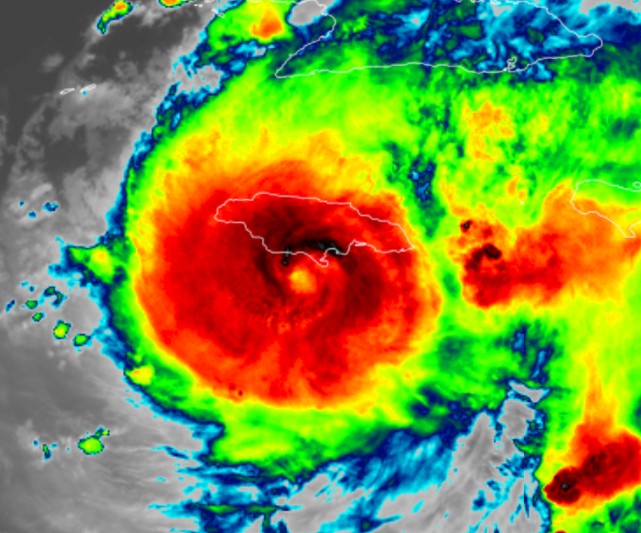 Satellite image of Hurricane Beryl crossing Jamaica in early July 2024. There is a deep red in the centre of the hurricane with greens and blues on the outside showing different cloud heights.